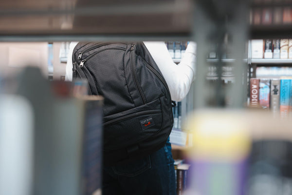 A person wearing a Spectron Synik 26 in a library